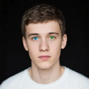 A studio headshot of a young man with one blue eye and one green eye (heterochromia). - Bytedance Seedream 3.0