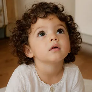 A hyper-realistic photo of a toddler with curly hair and big eyes, looking upward. - OpenAI GPT Image 2
