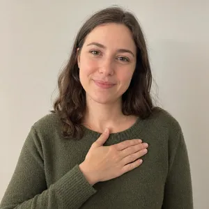Photorealistic close-up portrait of a person clearly performing the American Sign Language gesture for 
