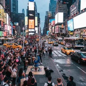 A busy city intersection with cars, pedestrians, and street performers all in one frame. - Google Nano Banana 2 Lite