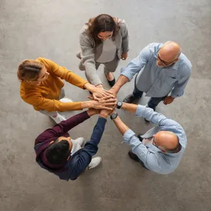 A group of five people joining hands in a circle, seen from above. - Black Forest Labs FLUX.2 Max