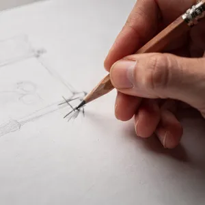 A hand drawing a sketch on paper with a pencil, the hand and pencil tip in clear focus. - Black Forest Labs FLUX.2 Max