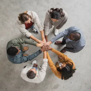 A group of five people joining hands in a circle, seen from above. - Black Forest Labs Flux 2 Pro