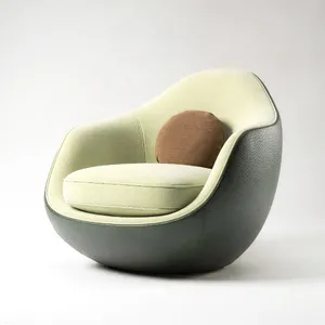 An armchair designed in the shape of an avocado, presented in a contemporary product photography style with professional studio lighting against a minimalist background. - Black Forest Labs Flux 2 Pro