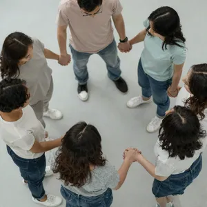 A group of five people joining hands in a circle, seen from above. - Alibaba Z-Image Turbo