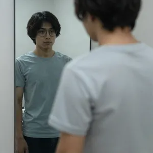 A person standing before a mirror, with their front and reflected back both visible. - Alibaba Z-Image Turbo