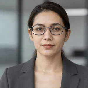 A professional headshot of a businesswoman wearing glasses, against a blurred background. - Alibaba Z-Image Turbo