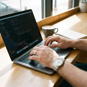 A person typing on a laptop keyboard, showing both hands on the keys. - Google Nano Banana Pro