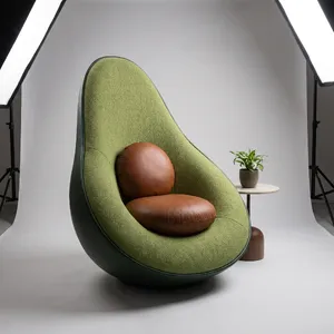 An armchair designed in the shape of an avocado, presented in a contemporary product photography style with professional studio lighting against a minimalist background. - Google Nano Banana Pro