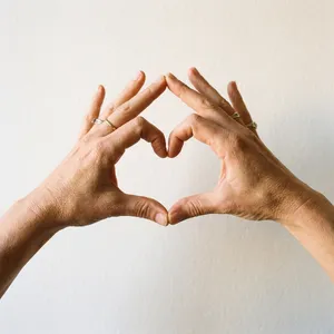 Two hands forming a heart shape together against a plain background. - Google Nano Banana Pro