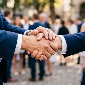 A close-up of two people shaking hands, both hands fully visible with five fingers each, in sharp focus against a blurred background. - Google Nano Banana 2