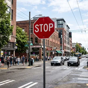 A red stop sign on a street corner displaying the word 