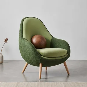 An armchair designed in the shape of an avocado, presented in a contemporary product photography style with professional studio lighting against a minimalist background. - Google Nano Banana 2