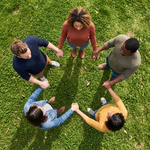 A group of five people joining hands in a circle, seen from above. - Google Nano Banana 2.1
