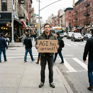 Photorealistic daytime street photograph, clearly showing a man standing still on a busy urban street corner holding a rectangular cardboard sign clearly facing camera, handwritten bold black marker text clearly readable as 