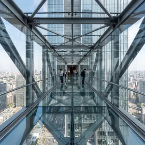 Photorealistic rendering of a contemporary glass skybridge between two skyscrapers, seen from inside with city views visible through glass walls and floor. Show accurate reflections and structural details. - Google Nano Banana 2.1