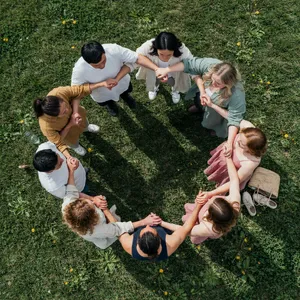 A group of five people joining hands in a circle, seen from above. - Ideogram Ideogram 4.0 (Quality)