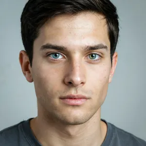 A studio headshot of a young man with one blue eye and one green eye (heterochromia). - Ideogram Ideogram 4.0 (Quality)