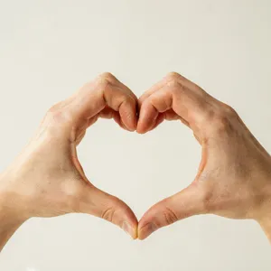 Two hands forming a heart shape together against a plain background. - Ideogram Ideogram 4.0 (Quality)
