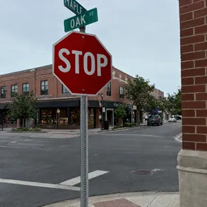 A red stop sign on a street corner displaying the word 