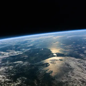 Photorealistic aerial photograph clearly showing the edge of the Earth from space, capturing realistic curvature, atmosphere, and sunlight reflections - OpenAI GPT Image 2.5 Flare