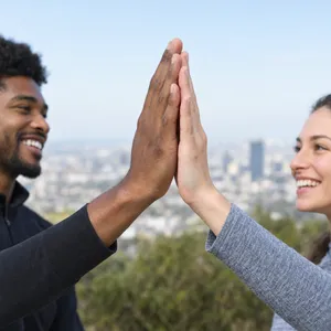 Two people high-fiving, with focus on their hands meeting mid-air. - OpenAI GPT Image 2.5 Flare