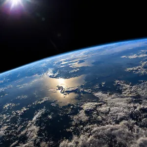 Photorealistic aerial photograph clearly showing the edge of the Earth from space, capturing realistic curvature, atmosphere, and sunlight reflections - OpenAI GPT Image 2.5 Sunburst