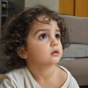 A hyper-realistic photo of a toddler with curly hair and big eyes, looking upward. - OpenAI GPT Image 2