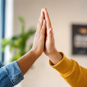 Two people high-fiving, with focus on their hands meeting mid-air. - OpenAI GPT Image 2