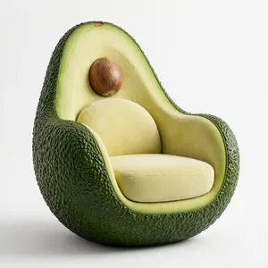 An armchair designed in the shape of an avocado, presented in a contemporary product photography style with professional studio lighting against a minimalist background. - Meta Muse Image