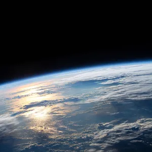 Photorealistic aerial photograph clearly showing the edge of the Earth from space, capturing realistic curvature, atmosphere, and sunlight reflections - Meta Muse Image