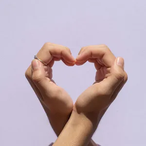 Two hands forming a heart shape together against a plain background. - XAI Grok Imagine (Quality)