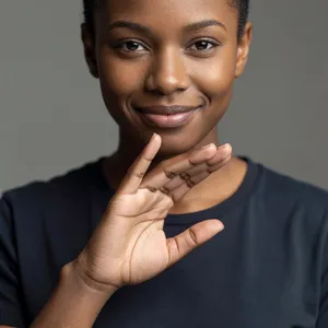 Photorealistic close-up portrait of a person clearly performing the American Sign Language gesture for 