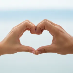 Two hands forming a heart shape together against a plain background. - Google Nano Banana (2.5 Flash)