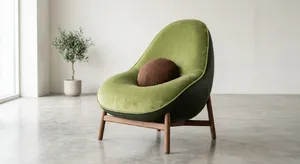 An armchair designed in the shape of an avocado, presented in a contemporary product photography style with professional studio lighting against a minimalist background. - Google Nano Banana 2