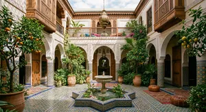 A traditional Moroccan riad courtyard with detailed zellige tilework, flowing fountain, citrus trees, and ornate woodwork. Morning light casting intricate shadow patterns. - Google Nano Banana 2