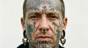 A portrait of a person with elaborate facial tattoos and piercings, shown in sharp detail. - Google Nano Banana Pro
