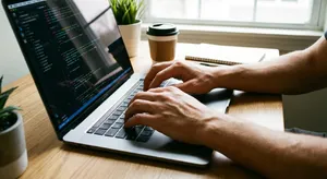 A person typing on a laptop keyboard, showing both hands on the keys. - Google Nano Banana Pro