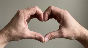Two hands forming a heart shape together against a plain background. - Google Nano Banana Pro