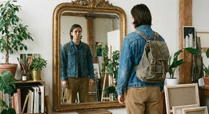 A person standing before a mirror, with their front and reflected back both visible. - Google Nano Banana Pro