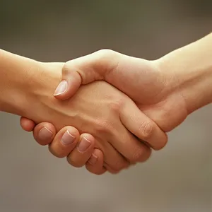 A close-up of two people shaking hands, both hands fully visible with five fingers each, in sharp focus against a blurred background. - Midjourney Midjourney V6.1