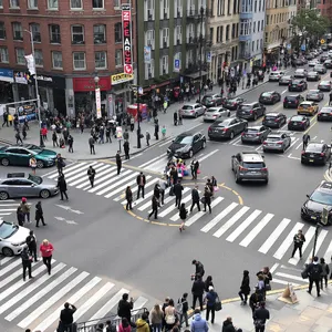 A busy city intersection with cars, pedestrians, and street performers all in one frame. - Black Forest Labs Flux 1.1 Pro Ultra