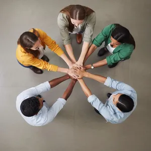 A group of five people joining hands in a circle, seen from above. - Black Forest Labs FLUX.2 Max