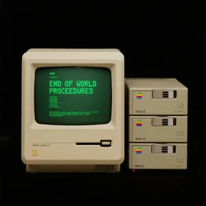 Vintage Apple II computer with green monochrome CRT screen, displaying 'END OF WORLD PROCEDURES' in green text. Two external floppy drives stacked on the right, labeled disk II with rainbow Apple logos. Beige casing, black background, retro aesthetic. - Bytedance Seedream 3.0