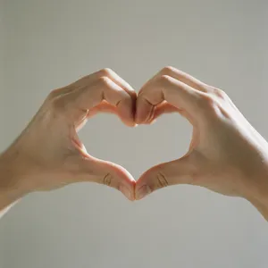 Two hands forming a heart shape together against a plain background. - Bytedance Seedream 5.0 Pro
