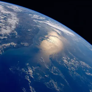 Photorealistic aerial photograph clearly showing the edge of the Earth from space, capturing realistic curvature, atmosphere, and sunlight reflections - Takumi Takumi 1