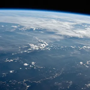 Photorealistic aerial photograph clearly showing the edge of the Earth from space, capturing realistic curvature, atmosphere, and sunlight reflections - Alibaba Z-Image Turbo