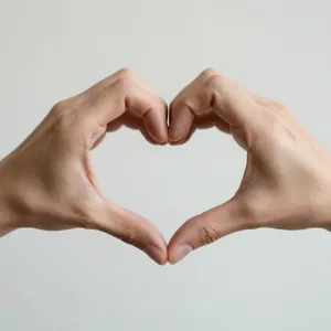 Two hands forming a heart shape together against a plain background. - Alibaba Z-Image Turbo