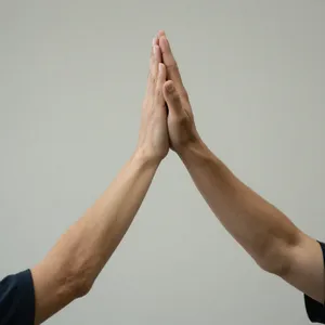 Two people high-fiving, with focus on their hands meeting mid-air. - Alibaba Z-Image Turbo