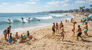 A beach scene: adults playing volleyball, kids building sandcastles, and surfers riding waves. - Google Nano Banana 2 Lite